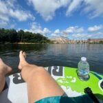 A picture of the author sitting on a river tube overlooking a dam in the Catawba River.