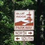 Image of the Blue RIdge Parkway sign pointing north and south.