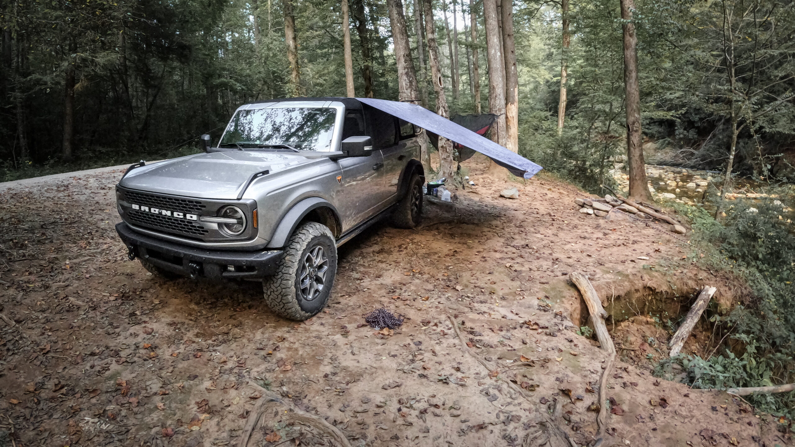 Ford Bronco with tent on side next to forest road in Pisgah National Forest